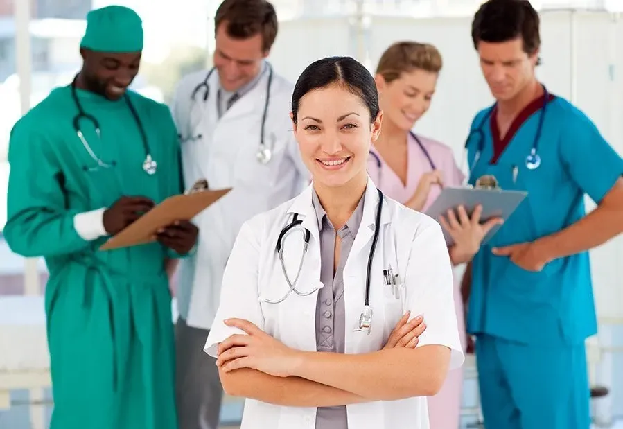 A team of doctors and nurses reviewing notes together