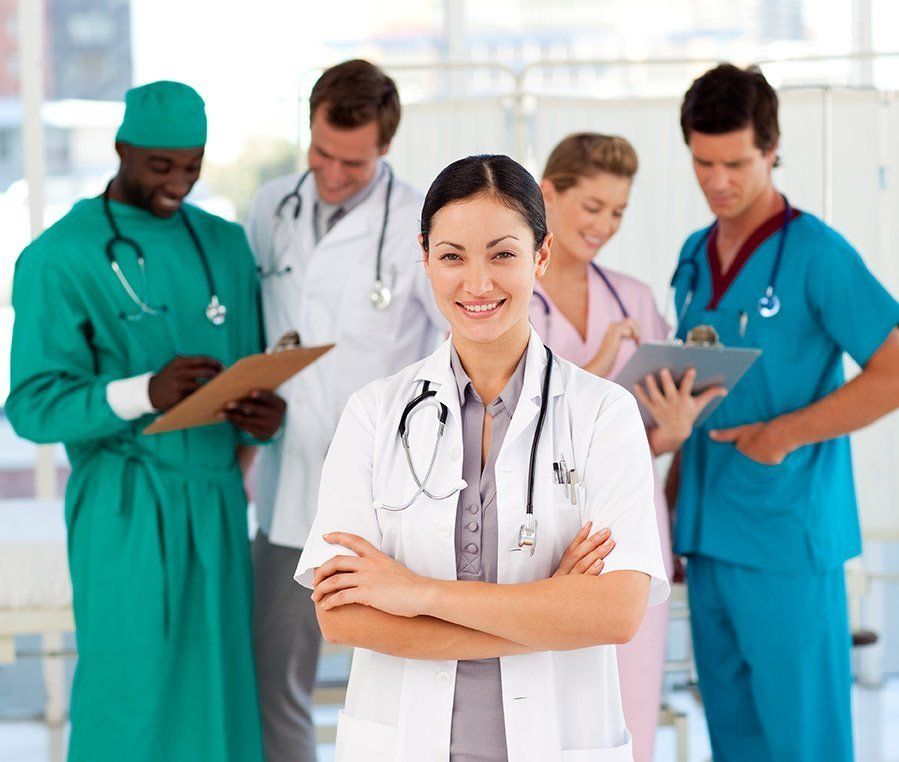 A hospital team of physicians and nurses reviewing notes together
